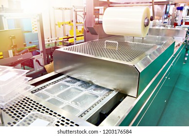 Conveyor at food factory for packing plastic containers