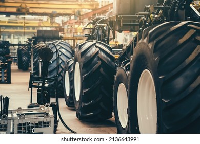 Conveyor line for production and assembly of large industrial machines, tractors or combines with big rubber tires in factory - Shutterstock ID 2136643991