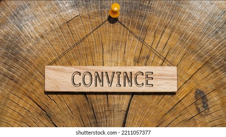 Convince Text. Written On Wooden Hanging Frame. Background Wood Cut Log