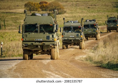 Convoy Of British Army MAN SV 8x8 EPLS Logistics Trucks Driving An Unmade Road On A Military Exercise UK