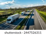 Convoy of White Trucks with containers on highway, cargo transportation concept at sunset - freight service