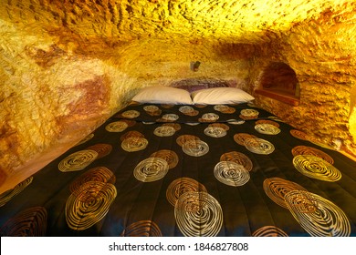 Coober Pedy, South Australia, Australia - Aug 28, 2019:Underground bed of an underground house carved in stone. Coober Pedy mining town of Australia. in the desert of South Australia of outback.