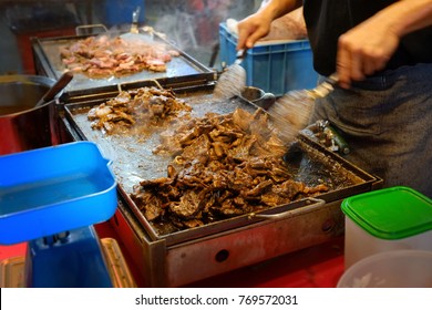 Cook In Action Roasting Mutton Black Pepper Steaks At Night Market Kuala Lumpur, Malaysia. 