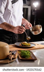 Cook adding some sauce to dish. Cropped chef preparing food, meal, in kitchen, chef cooking, Chef decorating dish, closeup - Shutterstock ID 1923170162