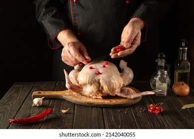 The Cook Adds Red Viburnum To The Broiler Chicken Before Roasting. Cooking National Dishes In The Kitchen Of The Restaurant.