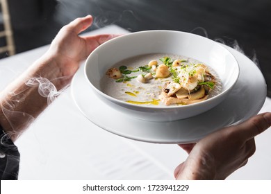 Cook Chef Making Creme Soup With Herbs, Mushrooms, Scallops And Toast Bred - Added Dried Ice For Smoking Effect.