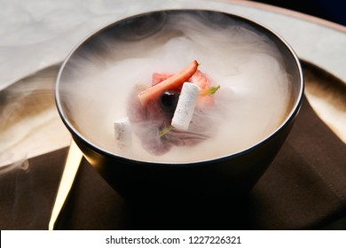 Cook Chef Making Fruit Ice Cream Added Liquid Nitrogen. Cold Dessert Food With Dry Ice Smoke In Plate, Close-up