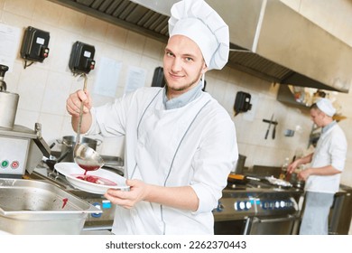 cook chef preparing food in restaurant kitchen - Powered by Shutterstock