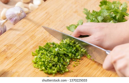 Cook Chopped Green Coriander On A Wooden Board