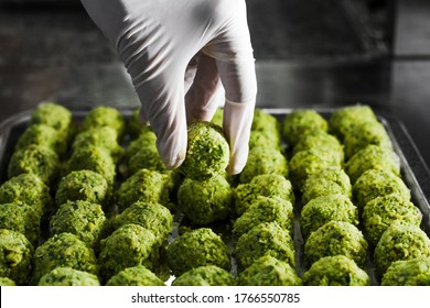 Cook cooks falafel by laying balls on the board. The national dish of Israel. Fried chickpeas. a vegetarian dish. Patern