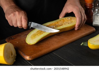 The Cook Cuts Ripe Yellow Marrow With A Knife. Fried Zucchini Is A Great Diet For Breakfast Or Lunch. Work Environment On The Kitchen Table Of The Restaurant.