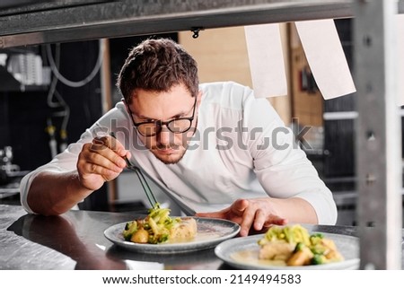Cook decorating dish before delivery