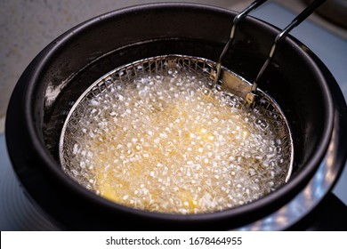 cook French fries. oil boiling in a deep fryer at home. top view. close up. - Shutterstock ID 1678464955