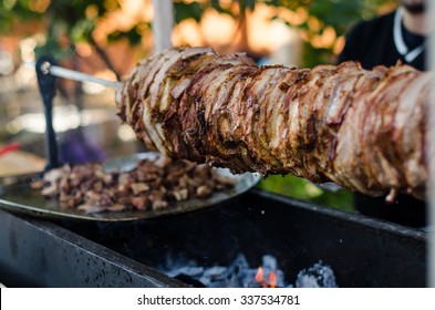 Cook Fries Grilled Meat Shawarma . Hot Fresh Delicious Kebabs - A Fine Selection Of Street Food . Charcoal And Meat Close-up.
