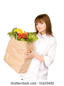 cook girl holding a paper bag with vegetables