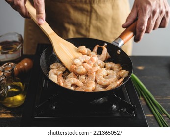 Cook hands cooking big tiger shrimps and frying on wok pan, close up steps recipe on kitchen background  - Shutterstock ID 2213650527