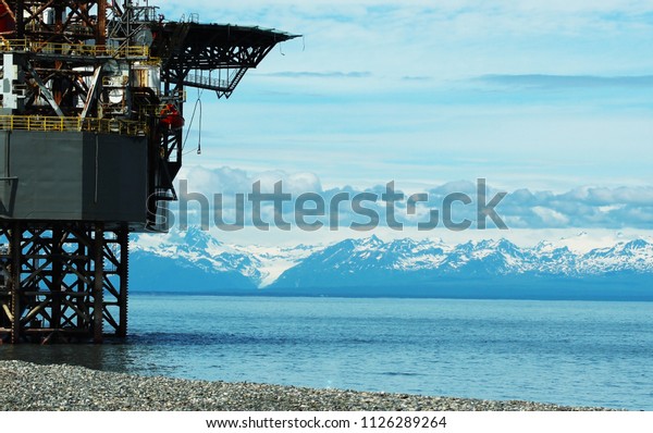 Cook Inlet and mountains with Oil platform\
service station
