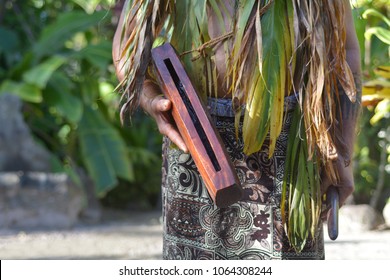 Cook Islander Man Plays On A Small Pate Wooden Stick Drum Instrument In Rarotonga, Cook Islands.Rael People. Copy Space