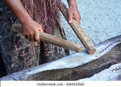 Cook Islander Man Plays On A Large Wooden Log Pate Drum Instrument In Rarotonga, Cook Islands.Rael People. Copy Space