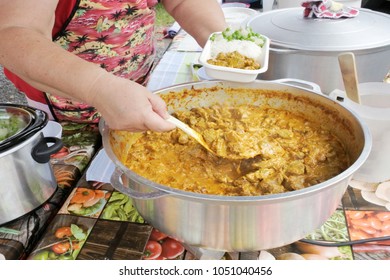 Cook Islander Woman Serving Chicken With Coconut Cream With Rice In A Plate In Rarotonga Cook Islands. Food Background And Texture. Copy Space