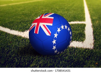 Cook Islands flag on ball at corner kick position, soccer field background. National football theme on green grass. - Powered by Shutterstock