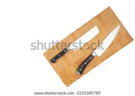 Cook Knife on the wooden endgrain cutting board above white background.