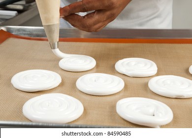 Cook Making Meringue Circles With A Piping Bag