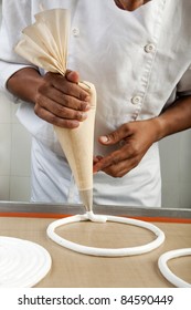 Cook Making Meringue Rings With A Piping Bag