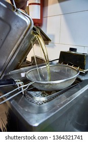 Cook Pouring (refilling) Liters Of Refined Oil For Deep Fat Frying In Electric Modern Heating Machine. Unhealthy Fat Not Organic Vegetable Refined Sunflower Light Greasy Oil, Palmolein, Hydrogenated.