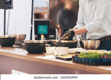  Cook prepares food on a demo advertisement.