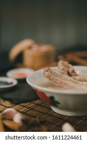 A cook is preparing a Bak kut teh for service to his customer in a Chinese restaurant.