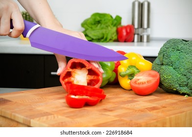 Cook preparing food, cut the peppers into slices
