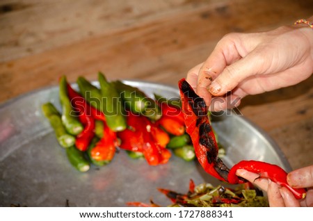 The cook is preparing ingredients for chili paste.
์Native food in Thailand.