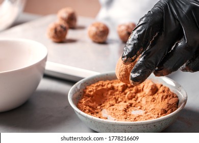 The Cook Rolls Date Balls In Carob Or Cocoa Powder.