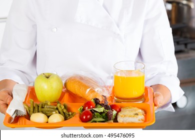 Cook In A School With A Tray Of Food