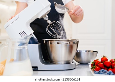 A Cook Sifts The Powdered Sugar Through A Sieve To Prepare Dough In A Mixer Bowl. Cooking Courses. Bread And Dessert Recipes. Family Business. Online Lessons For Cooks.