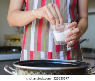 Cook Takes Cup Of Salt To Water In Bowl