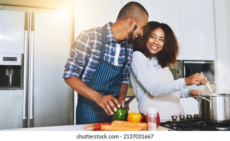 Cook Together To Make Food Better. Shot Of A Young Couple Cooking Together At Home.