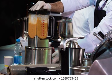 The Cook Uses A Mixer. Grinding Products In An Industrial Food Processor. Equipment Of Cafes And Restaurants. Stainless Steel Utensils And Appliances. The Chef At Work.