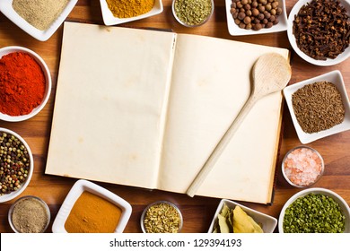 The cookbook and various spices and herbs.