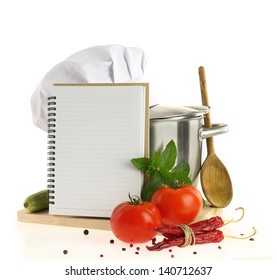 Cookbook, vegetables and casserole with chef hat isolated on white