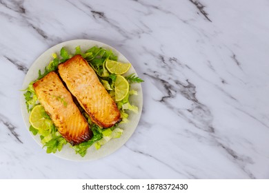 Cooked Atlantic Salmon In Plate With Salad And Lemon On White Background.