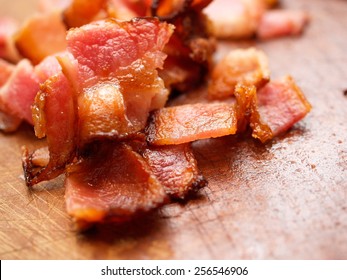 Cooked Bacon Pieces On Wood.