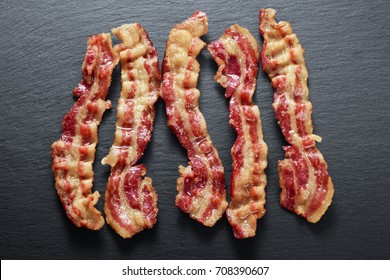 Cooked Bacon Rashers On The Background Of A Slate Board