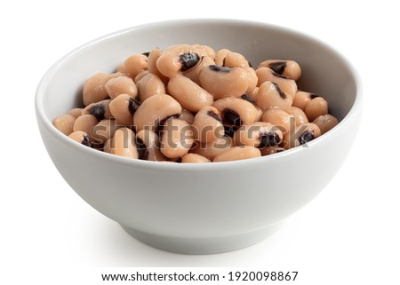 Cooked black-eyed beans in a white ceramic bowl isolated on white.