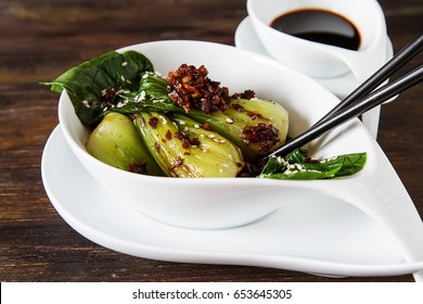 Cooked Bok Choy Or Chinese Cabbage With Sesame AndÂ  Soy Sauce. Simple Background. Healthy Food. Lifestyle