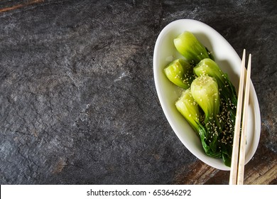 Cooked Bok Choy Or Chinese Cabbage With Sesame AndÂ  Soy Sauce. Simple Background. Healthy Food. Lifestyle