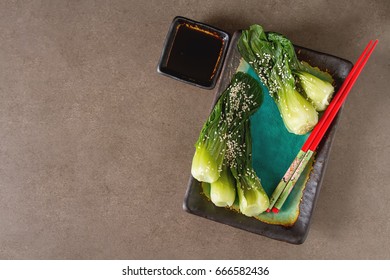 Cooked Bok Choy Or Chinese Cabbage With Sesame AndÂ  Soy Sauce. Simple Background. Healthy Food. Lifestyle