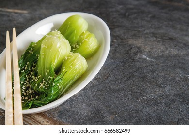 Cooked Bok Choy Or Chinese Cabbage With Sesame AndÂ  Soy Sauce. Simple Background. Healthy Food. Lifestyle