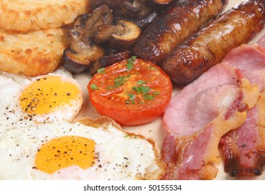 Cooked Breakfast With Bacon, Sausage, Eggs, Mushrooms And Hash Browns